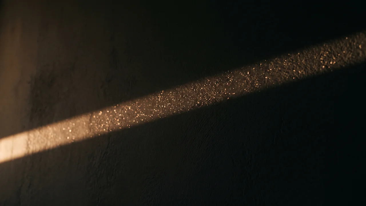 A beam of morning sun crosses a dark plaster wall